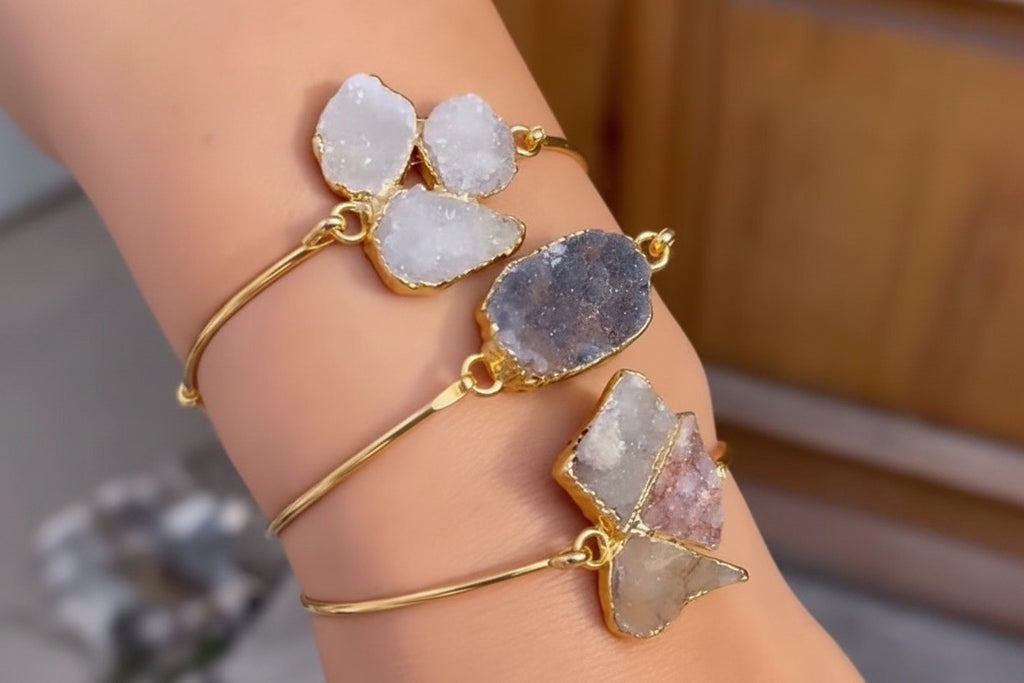 Bracelets with natural stone beads on a wrist against a blurred background